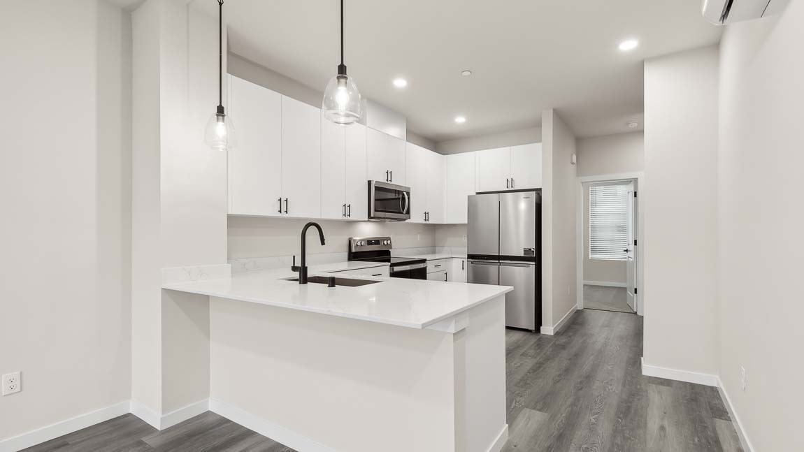 Spacious kitchen with quartz countertops and stainless-steel appliances