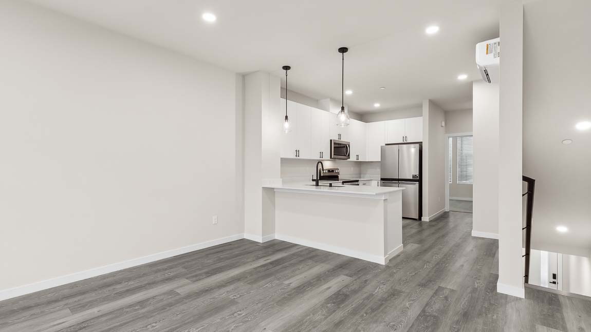 Dining and living room spaces open to kitchen area