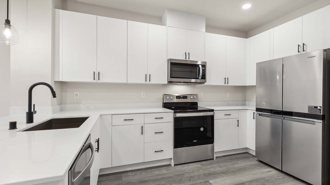 White cabinetry with ample storage space in kitchen