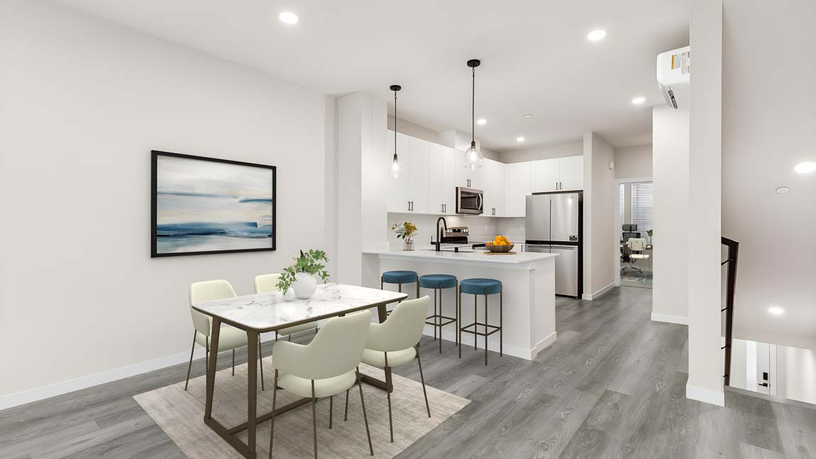 View of main floor dining area kitchen third bedroom and stairway access to lower floor