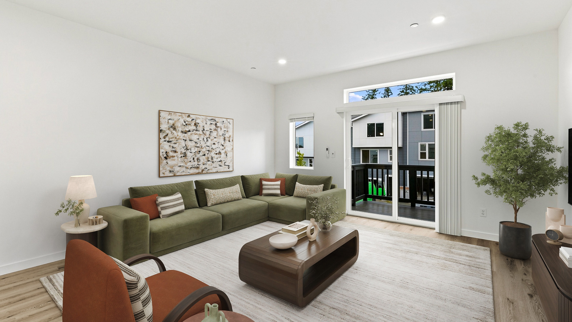 Contemporary living room with a green sectional sofa, wood coffee table, large windows, and sliding glass door opening to a covered balcony.