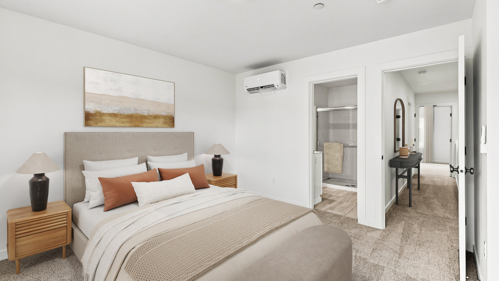 Primary bedroom with upholstered bed, neutral decor, bedside tables, en suite bathroom access, and soft carpeting.