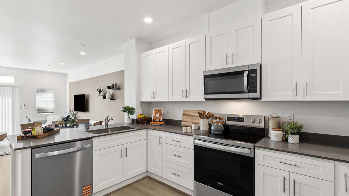 Beautiful white cabinetry in this modern kitchen with Stainless steel appliances