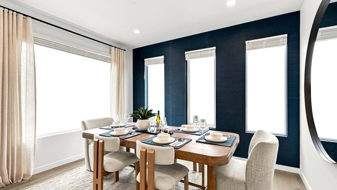 Elegant dining room with a modern wood dining table, upholstered chairs, floor-to-ceiling windows, and a striking accent wall, creating a bright and inviting space for entertaining.