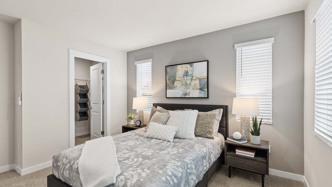 Another angle of the primary bedroom with a peak into the large walk-in closet