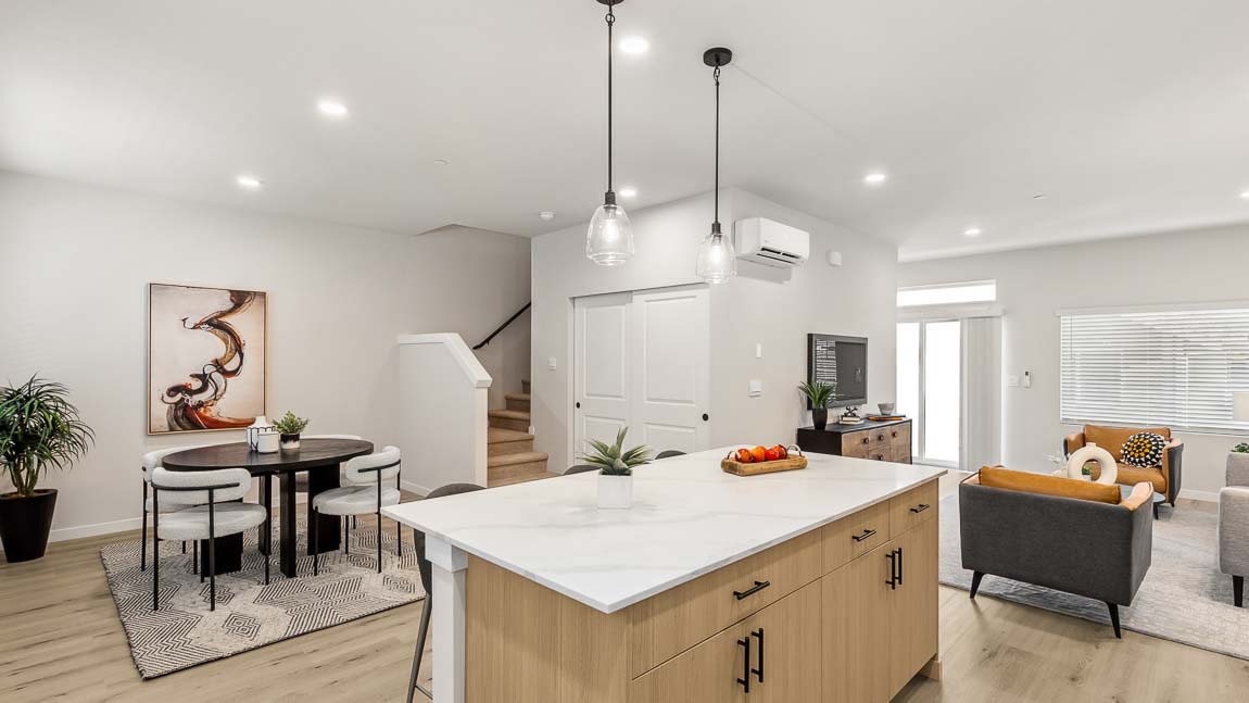 Open concept at its finest showcasing the easy of living between living, dining, and kitchen spaces