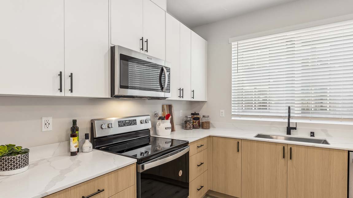 close up of kitchen sink with large picture window