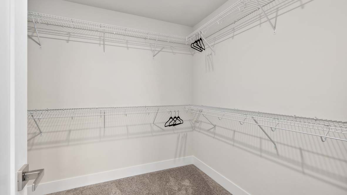 Walk-in closet with wraparound upper and lower shelving