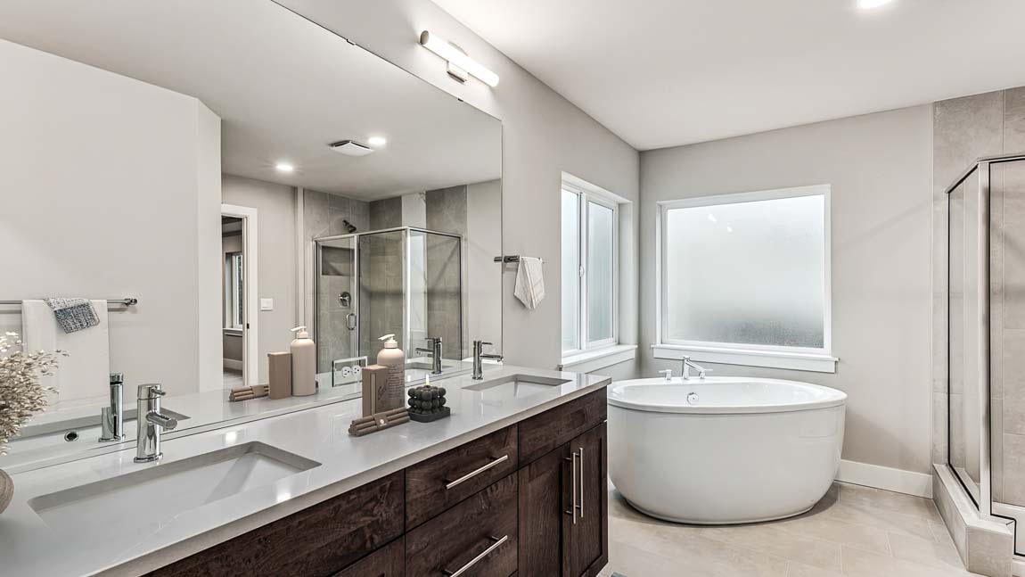 Spa like primary bathroom with 2 sink vanity, large soaking tub, and extra-large step in shower
