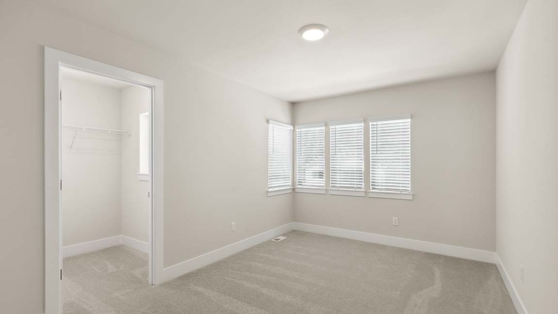 Bedroom three with large walk-in closet and lots of natural light