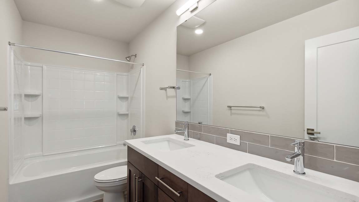 Upper floor hall bathroom with 2 sink vanity and shower tub combo
