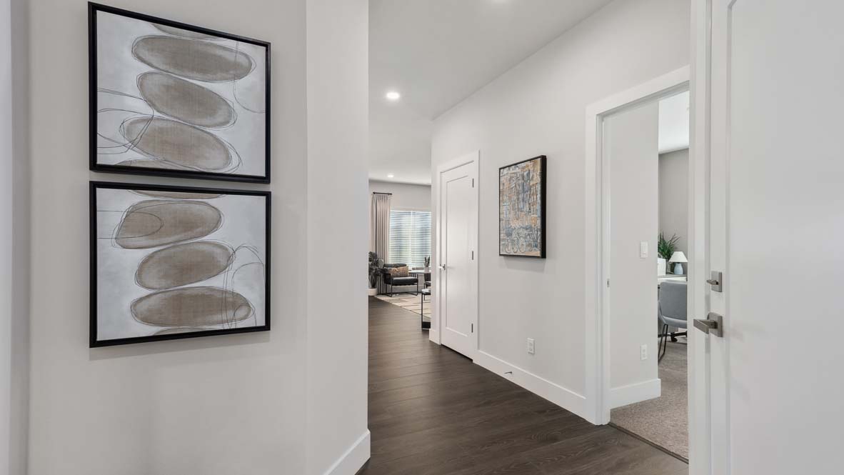 Main floor hallway showing den and living room of Newhalem plan built at Remington East