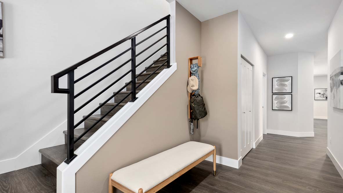 Newhalem plan entry foyer and stair landing with nearby storage closet and three-quarter bath