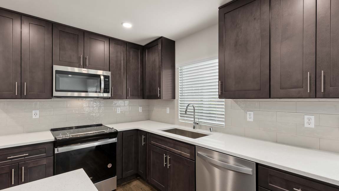 Open concept kitchen and living room with cozy electric fireplace