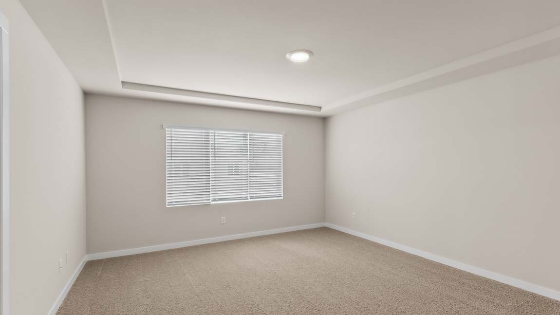 Primary bedroom suite with trace ceilings