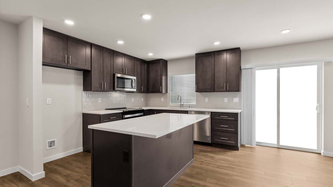 Beautiful and bright kitchen with dark modern cabinetry