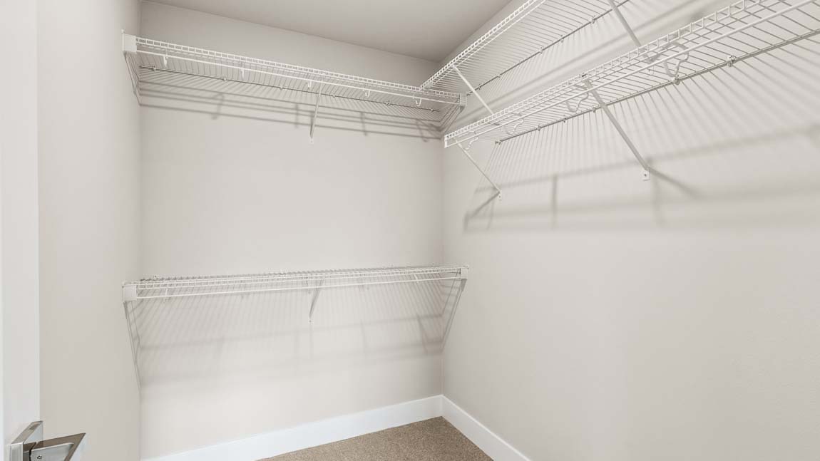 Primary bedroom walk-in closet
