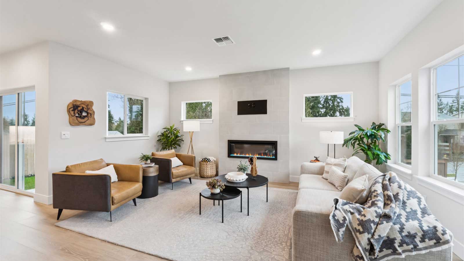 Spacious Living room with beautiful natural light and cozy electric fireplace