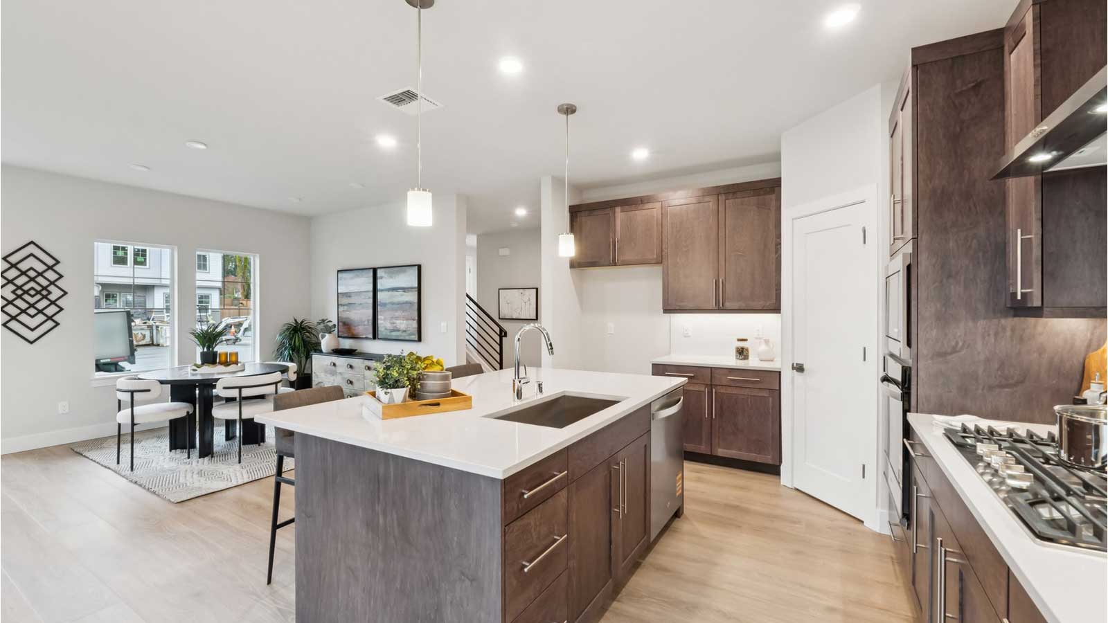 View from kitchen island into open concept dining and living