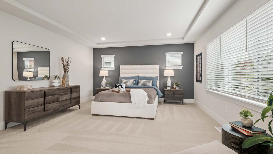 Primary bedroom with ample lighting and private en-suite bathroom