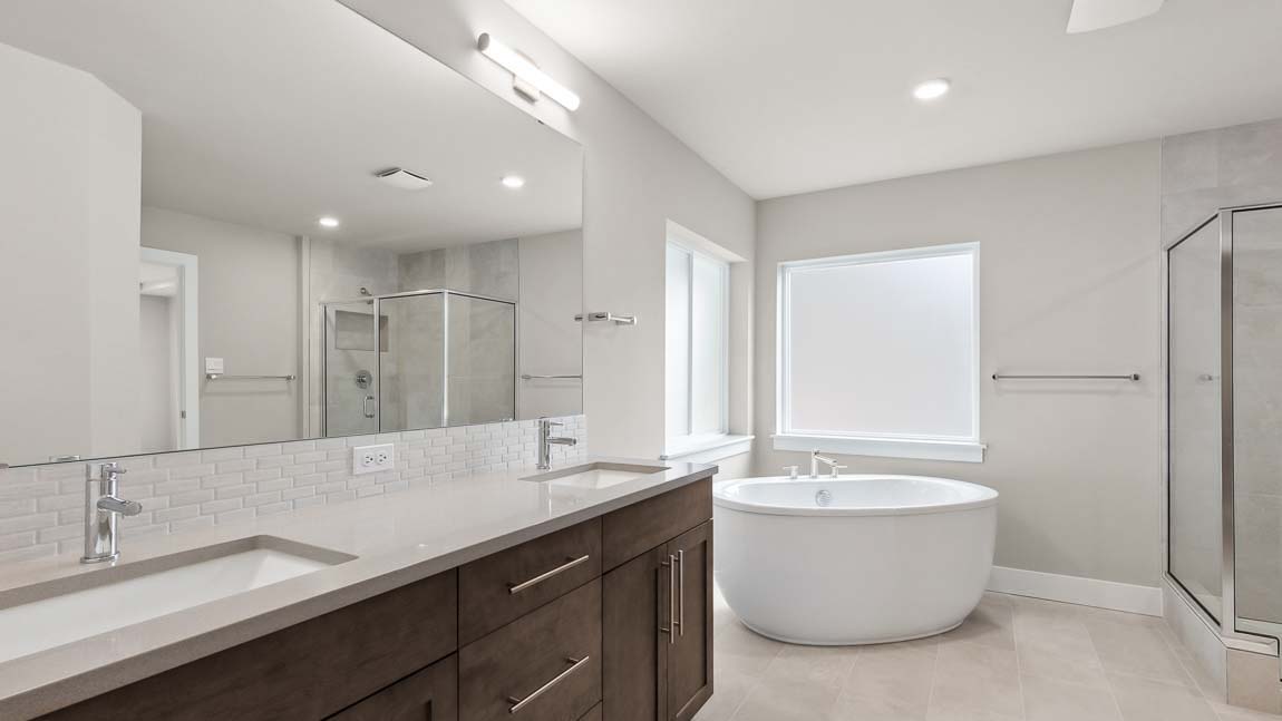 Beautiful primary bathroom with soaking tub and large step in shower