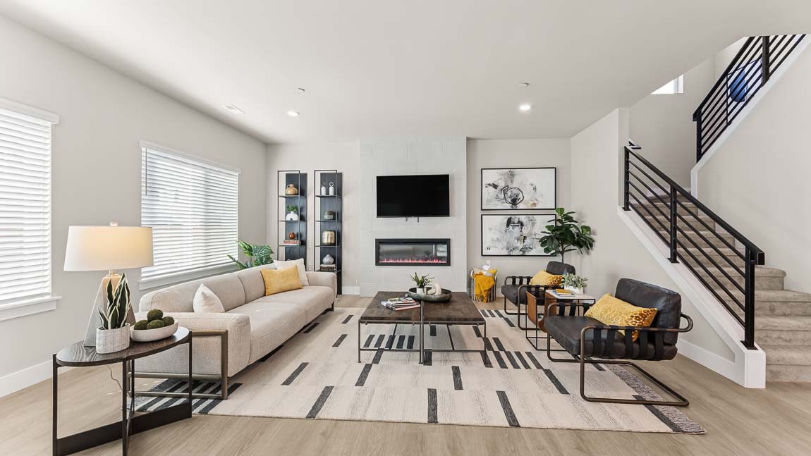 Spacious great room with hardwood flooring, recessed lighting and large windows