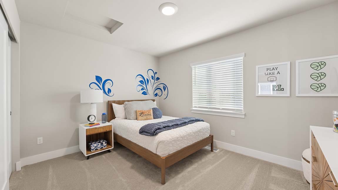 Third upper floor bedroom with plush carpeting next to secondary bathroom