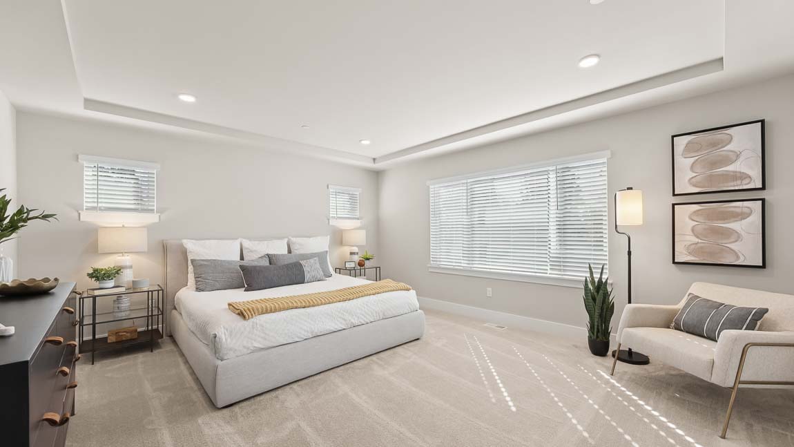 Primary bedroom with ample lighting and private en-suite bathroom