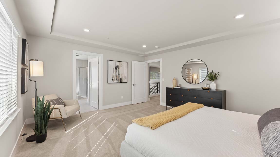 Primary bedroom peaking into the en-suite bathroom