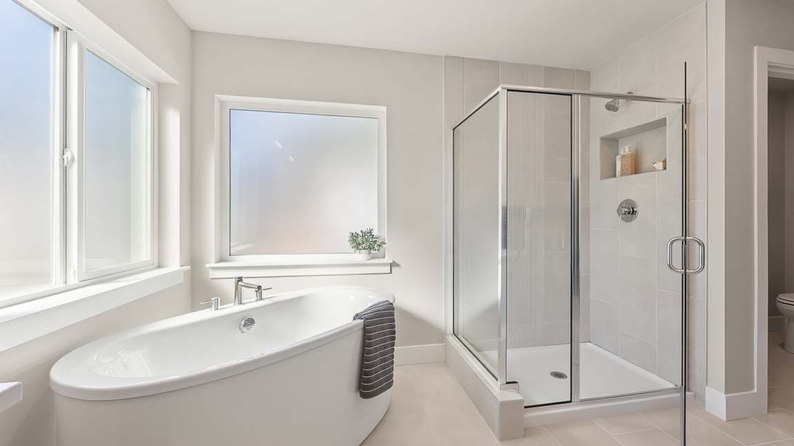 Primary bathroom featuring large step in shower and gorgeous soaking tub