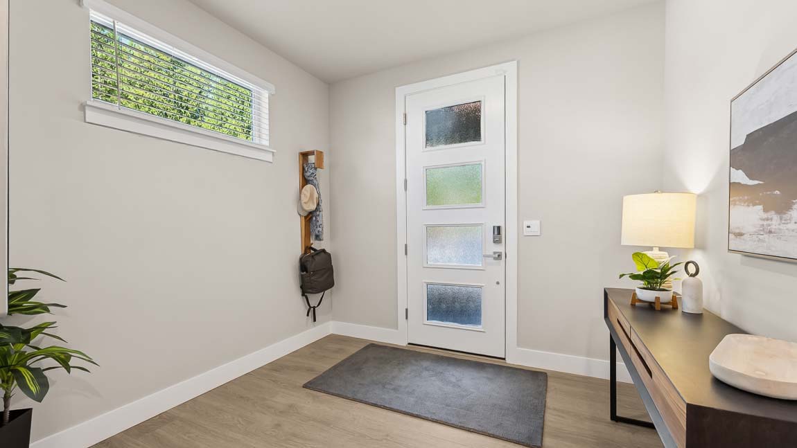 Entryway foyer and hallway view leading to fifth bedroom kitchen and main floor bathroom