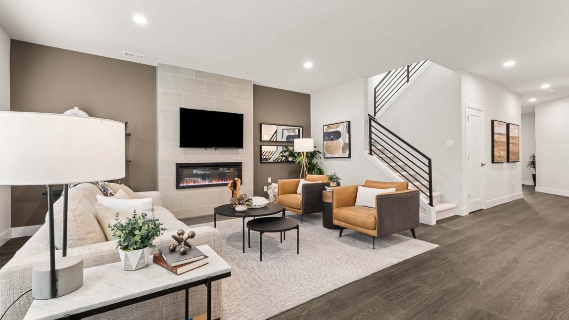 Living room showing access to stairs to upper floor