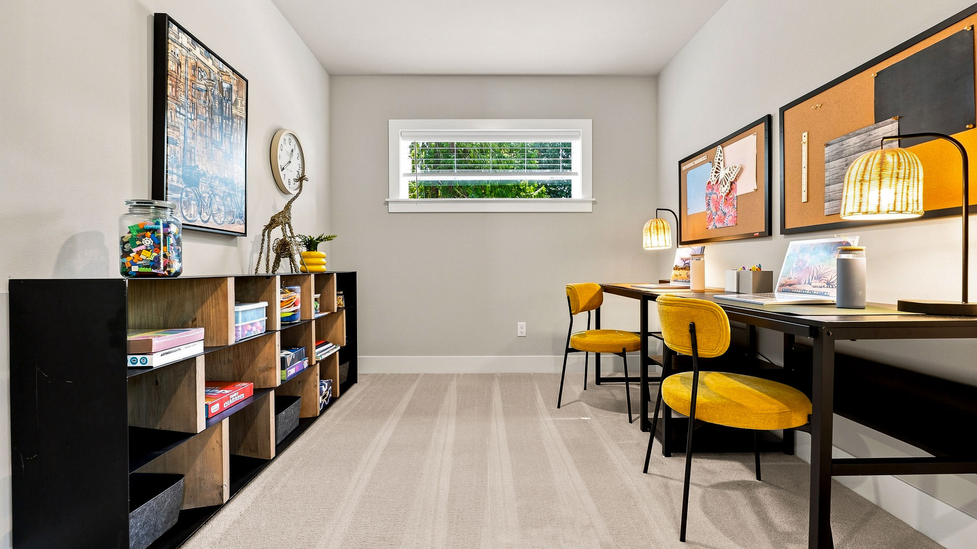 Flexible study or craft room with dual desks, yellow chairs, shelving unit, and task lighting.