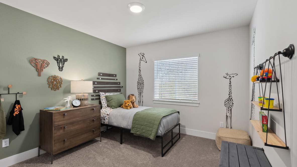 Child’s bedroom with single bed, animal-themed wall decals, dresser, shelving, and window with blinds.