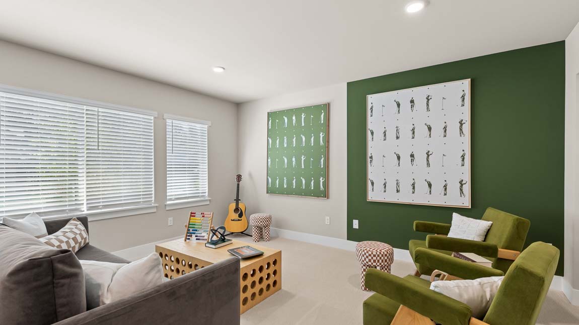 Bonus room with lounge seating, game table, guitar, large windows, and contemporary artwork.