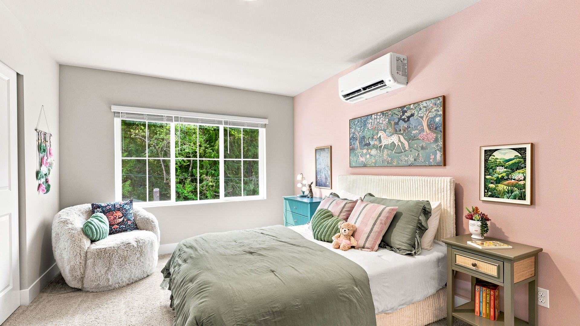Bedroom with pink accent wall, upholstered bed, colorful artwork, accent chair, and large window overlooking trees.