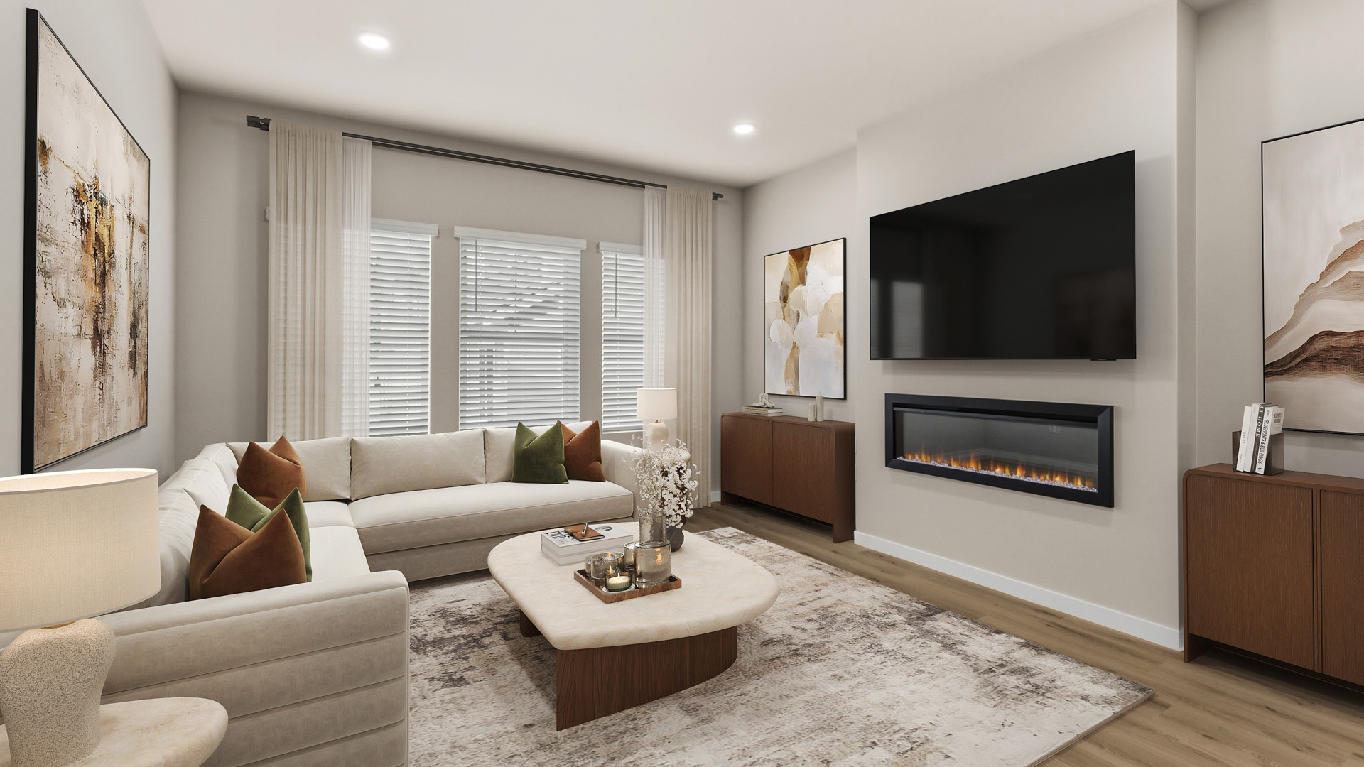 Contemporary living room with a cream sectional, green and brown pillows, rounded coffee table, large rug, wall-mounted TV, and linear fireplace.