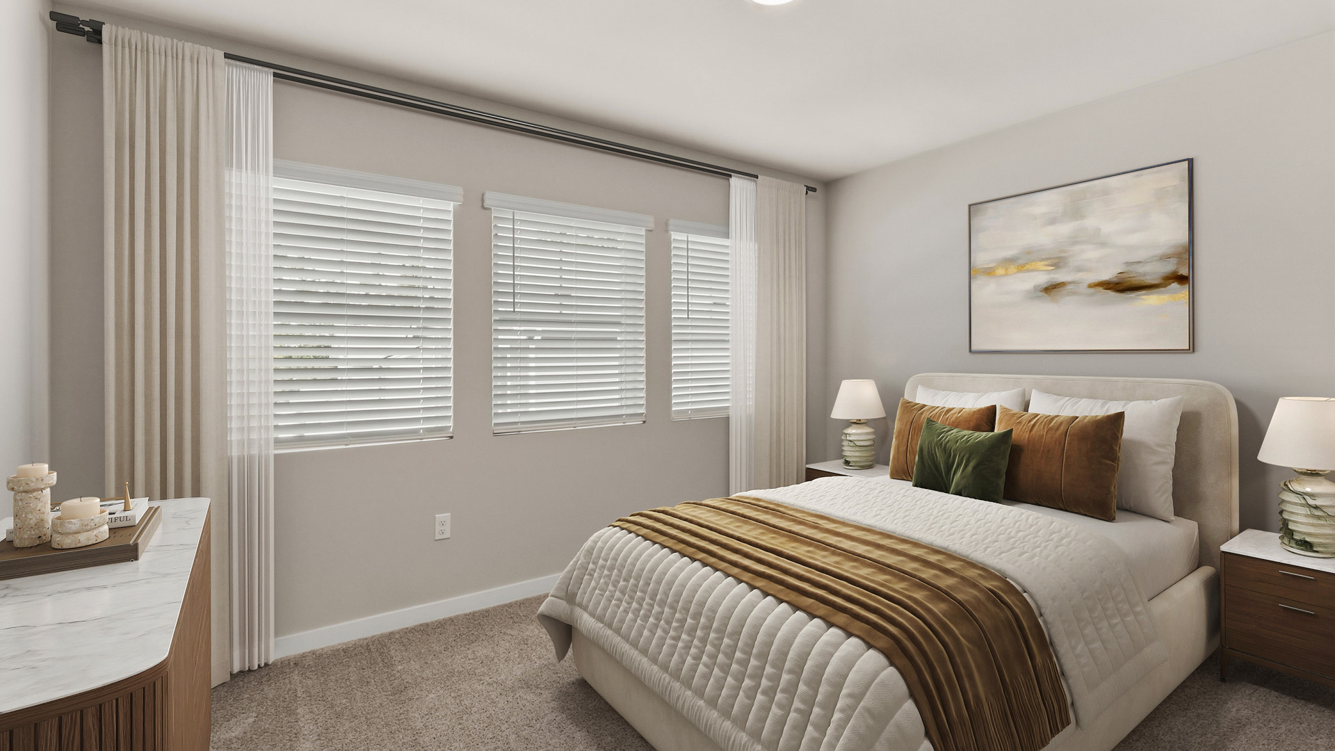 Bedroom with a cream upholstered bed, white quilted bedding, gold and green accent pillows, matching nightstands, three windows, and abstract wall art.