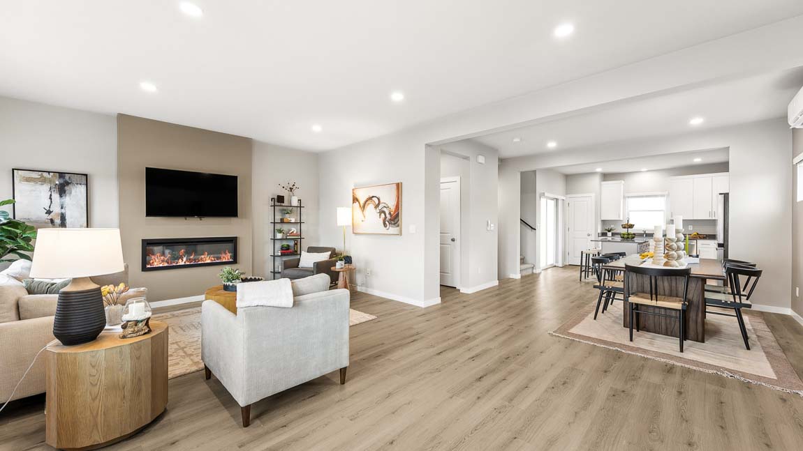 Expansive main floor view of the open-concept kitchen, dining, and living spaces