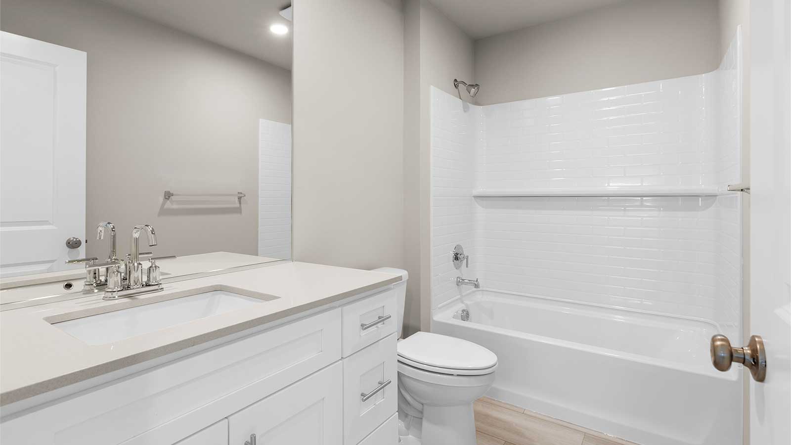 Hallway bathroom on the upper floor with shower/tub combo