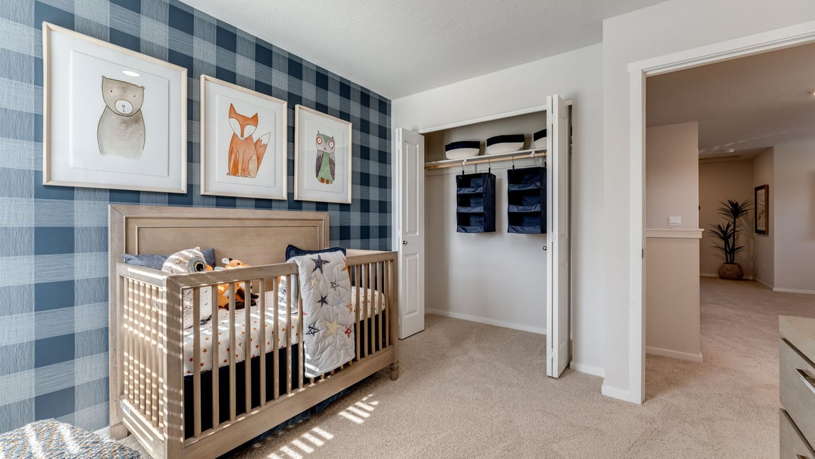 Child’s bedroom with wall-to-wall carpet and a closet