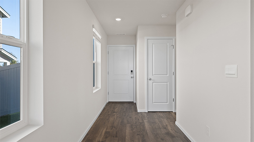 Entryway with a coat closet and laminate flooring