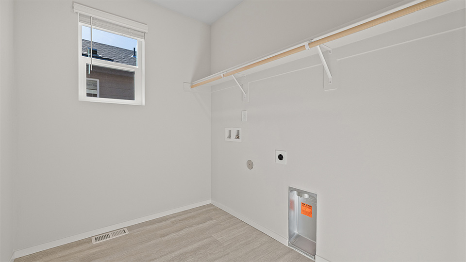 Laundry room with built-in shelves and washer and dryer hookups