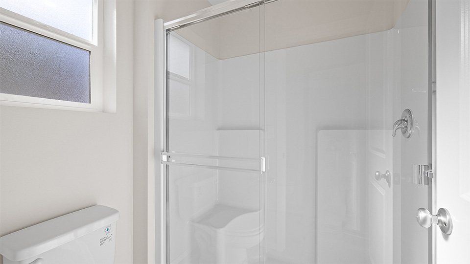 Primary bathroom with quartz counters and a walk-in shower