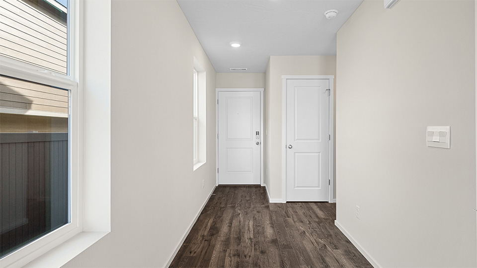 Entryway with a coat closet and laminate flooring