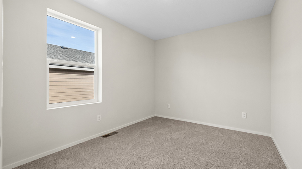 Bedroom with wall-to-wall carpet and a closet