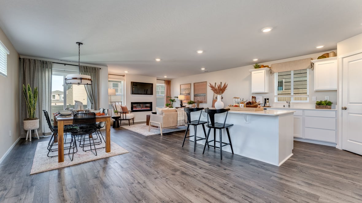Kitchen with shaker cabinets, quartz counters, stainless steel appliances, pantry, and an island with a breakfast bar