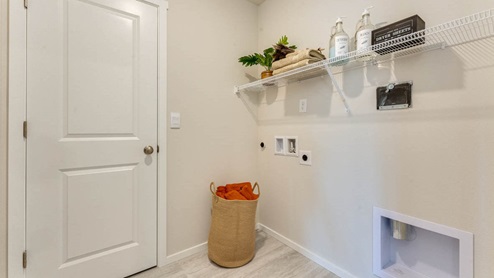 laundry room with white wire shelves