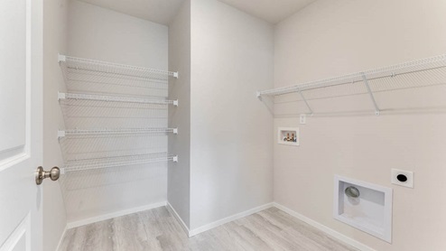laundry room with white wire shelves