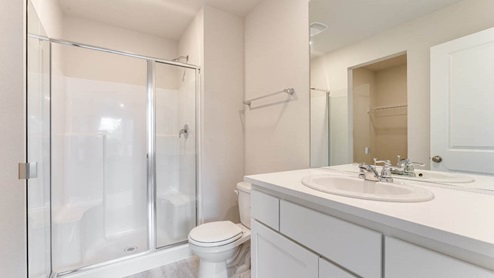primary primary bathroom with a walk-in shower with bench seats